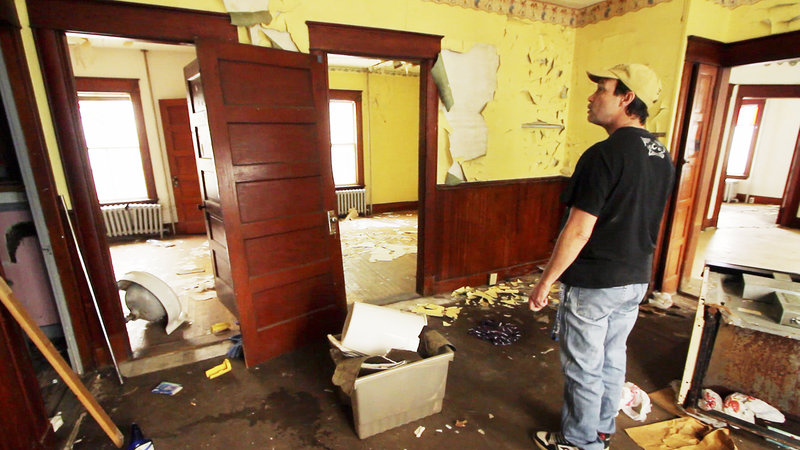 Shawn Greeley checks out the abandoned structure at 139 Bartlett St., across the street from his Lewiston apartment. He said he periodically visits the dwelling because homeless people sometimes occupy it.