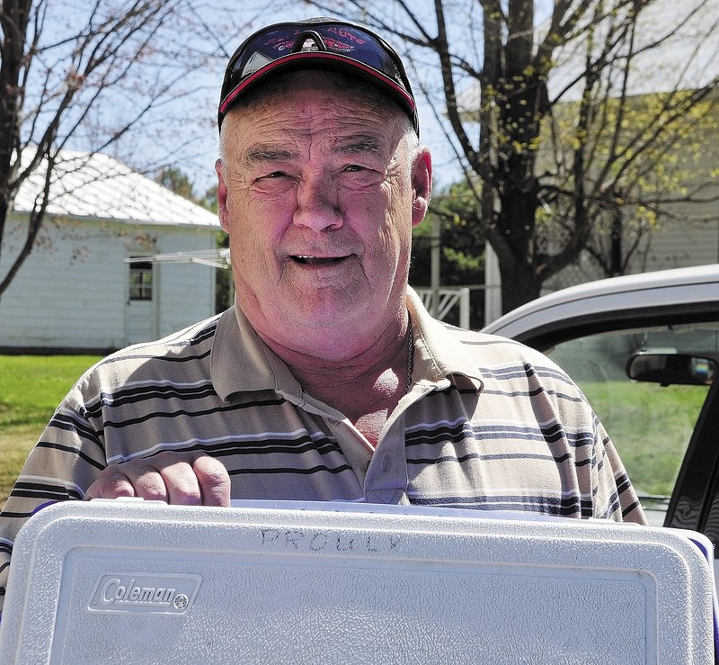 David Proulx reclaims a cooler and raincoat at the State Police Troop C barracks. He said his camp was burglarized twice a year for more than two decades.