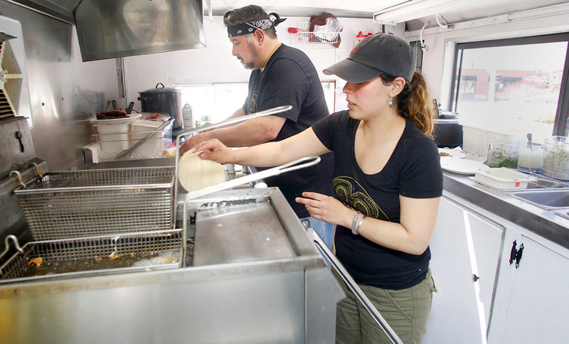 Chefs Joseph Urtuzuastegui and April Garcia at work in the Corazon kitchen.