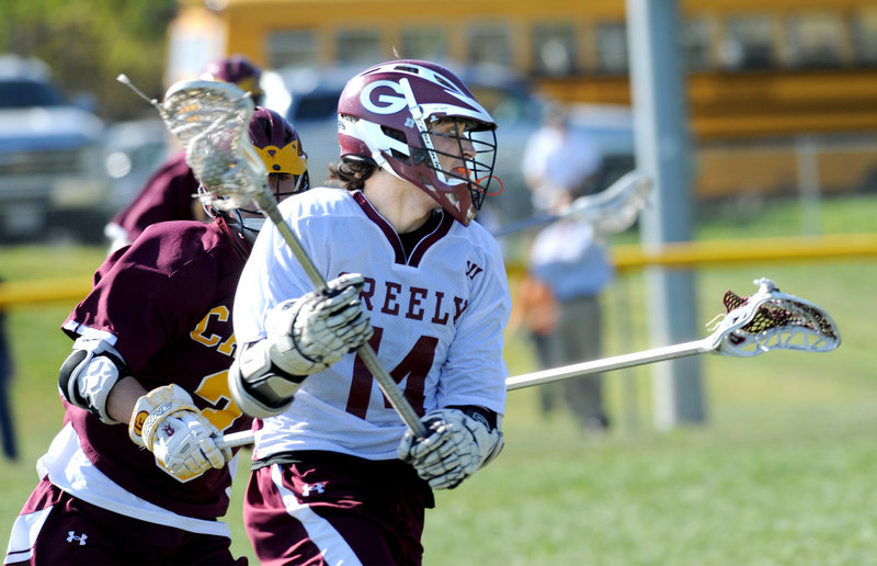 Brooks Belisle of Greely looks to move toward goal Tuesday while being chased by Brandon Negele of Cape Elizabeth during the Capers’ 8-4 victory in a showdown of Western Class B boys’ lacrosse powers.