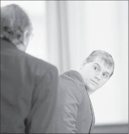 Dane Bosley looks toward a state marshal as he is led out of York County Superior Court in Alfred Tuesday after opening arguments in the state's case against him.