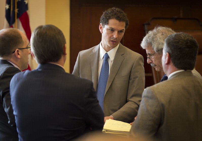 Senate President Justin Alfond, D-Portland, center speaks with Roger Sen. Katz, R-Augusta, right, and other senators during a session Thursday, June 13, 2013, at the State House in Augusta, Maine. Maine legislators return Wednesday to the State House, where observers expect them to override Gov. Paul LePage's veto of the proposed two-year, $6.3 billion state budget. (AP Photo/Robert F. Bukaty)