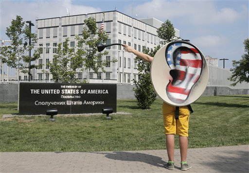 An activist of Ukraine's Internet party gestures as he demands the American authorities stop the pursuit of National Security Agency leaker Edward Snowden at a protest near the U.S. Embassy in Kiev Thursday.