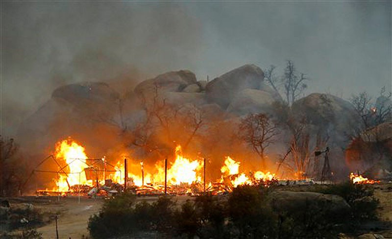 Homes burn as the Yarnell Hill fire burns in Glenn Ilah on Sunday near Yarnell, Ariz. The fire started Friday and picked up momentum as the area experienced high temperatures, low humidity and windy conditions. It has forced the evacuation of residents in the Peeples Valley area and in the town of Yarnell.
