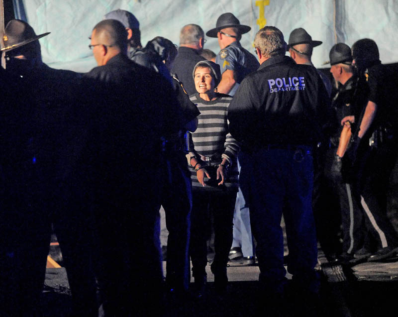 A protester is arrested after blocking the railroad crossing at Lawrence Avenue in Fairfield Thursday night, during protest of the transport of fracked oil.