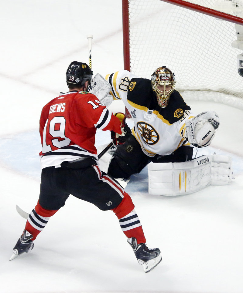 Bruins goalie Tuukka Rask makes a glove save as Chicago’s Jonathan Toews waits for a rebound during the second period Wednesday night.