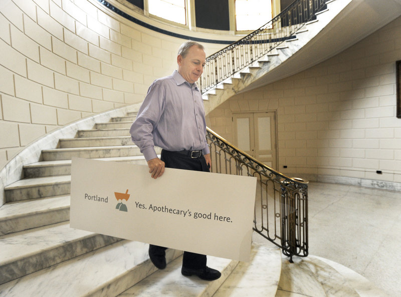 Apothecary owner Mark McAuliffe walks out of city hall Tuesday, June 18, 2013.after the city of Portland unveiled its new slogan to promote Portland: "Portland, Maine. Yes. Life's good here".