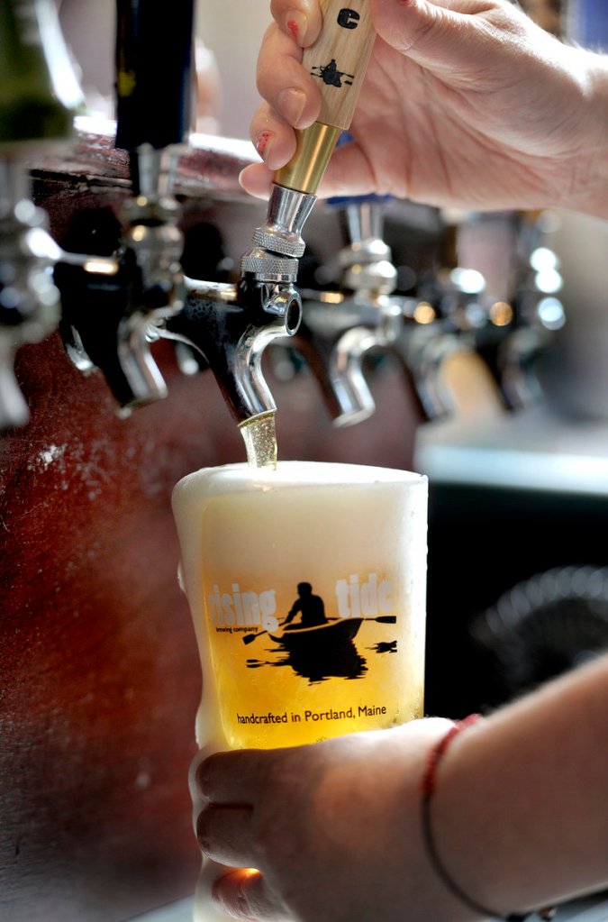 Allison Stevens pours a draft at her bar The Thirsty Pig on Exchange Street in Portland on Wednesday, June 19, 2013. Although the complete beer list for The Festival has not yet been released, there is an ever-growing list of confirmed beers and rarities that will be pouring throughout the weekend at the highly anticipated Portland event.