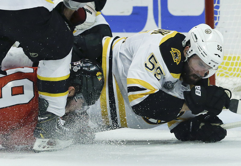 Jonathan Toews, left, of the Blackhawks suffered an apparent head injury in Game 5 on a hit late in the second period by Bruins defenseman Johnny Boychuk.