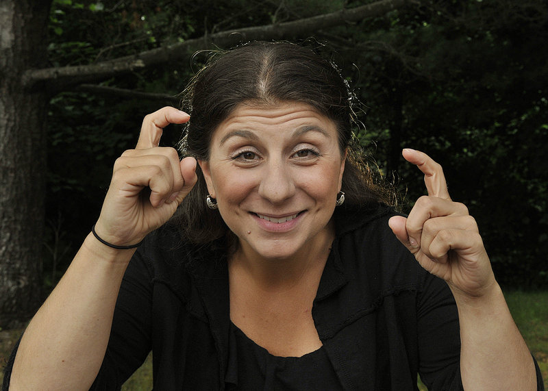 Holly Maniatty has made a name for herself as a sign language interpreter for live music concerts. “Everything I do is very strategic, to convey the emotion, the beat,” she said, mugging here with the sign for “camera.”