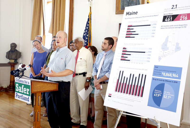 Portland City Councilor David Marshall speaks during a news conference about making marijuana legal in Portland, at Portland City Hall on Monday. On the board to the right are statistics depicting the disparities between blacks and whites in the arrest rates on marijuana possession charges.