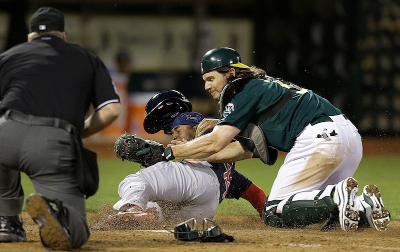 Boston Red Sox's Jackie Bradley Jr., center, is tagged out at home plate by Oakland Athletics catcher John Jaso in the ninth inning of a baseball game Friday, July 12, 2013, in Oakland, Calif. (AP Photo/Ben Margot)