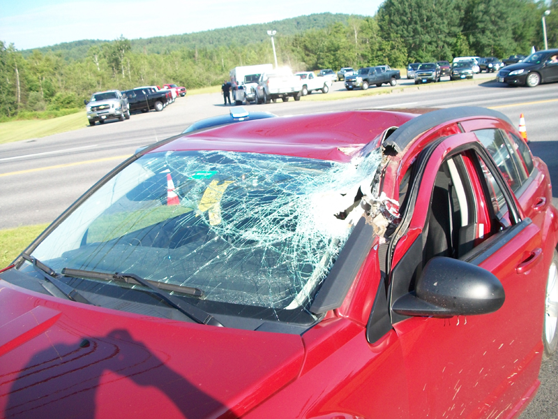 Sierra McGraw, 26, was driving south on Route 2 near Hight Chevrolet car dealership when her vehicle was hit by half of a manhole cover Wednesday morning.