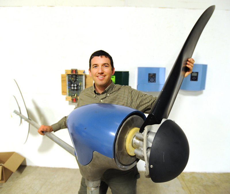 Ben Polito, president of Pika Energy in Westbrook, holds one of three blades on a wind turbine at his new facility.