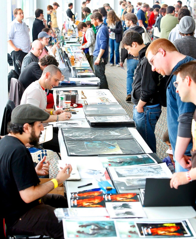 In this May 2013 file photo, comic book illustrators and visitors interact at Maine Comics Arts Festival at The Ocean Gateway in Portland. study released Wednesday shows that Portland's creative workforce continues to grow, but the organization that paid for the analysis says more needs to be done to attract artists, professionals and entrepreneurs to Maine's largest city.