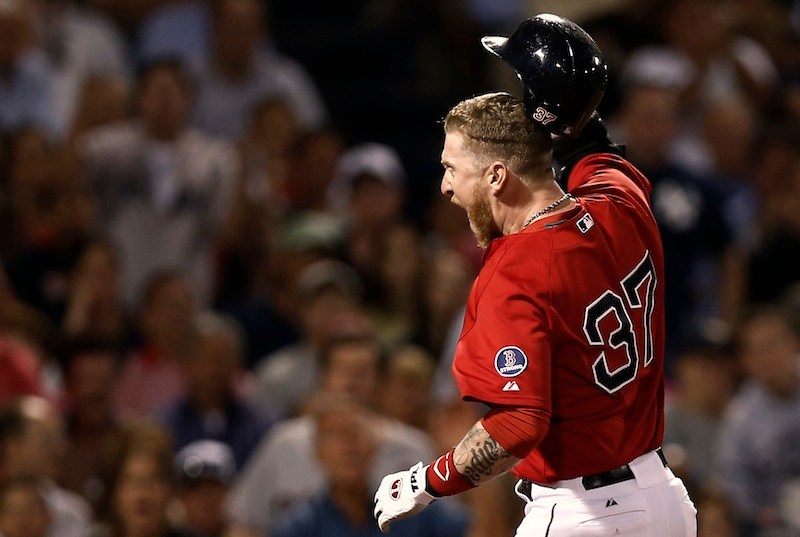 Boston's Mike Carp throws his helmet after being called out on strikes and then thrown out of the game by home plate umpire Bill Welke at Fenway Park in Boston Friday.