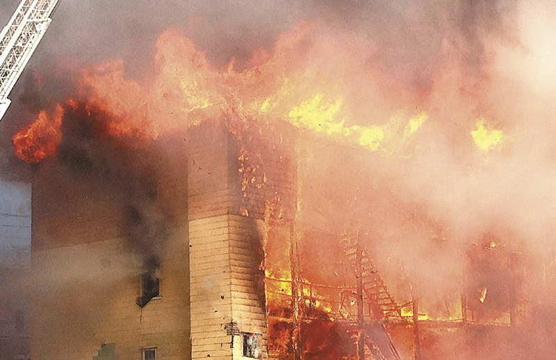 Fire consumes an apartment building in Lewiston on Monday, April 29. At least four apartment buildings were involved, with many more in peril. A 13-year-old boy accused of setting the fire in a densely populated section of downtown Lewiston confessesd in a police interview, but his attorney wants the confession tossed out, saying the boy wasn't wasn't properly Mirandized. (AP Photo / Sun-Journal Christopher Williams)