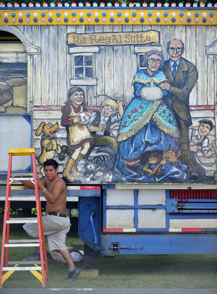 Gomzalo Calitto, 23, of Mexico, sets up the fun house as Fiesta Shows prepares for the Skowhegan State Fair at the Skowhegan Fairgrounds today.