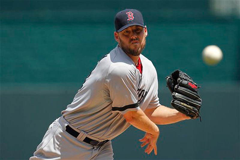 Boston Red Sox pitcher John Lackey warms up in the first inning of Sunday's game against the Kansas City Royals.