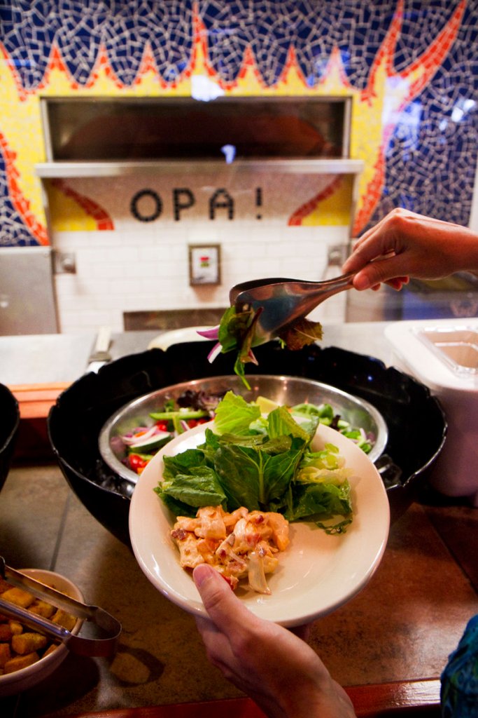 A diner gets salad in the self-service bar outside Jimmy the Greek's kitchen recently.