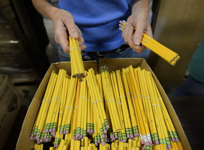 Lesley Reed, a volunteer from Unum, is prepared to hand out pencils to fill backpacks for needy students Wednesday, August 14, 2013.