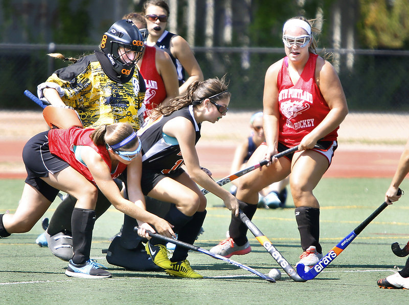 South Portland goalie Hannah Gato is surrounded by a mix of players as teammate Lydia Henderson, left, tries to poke the ball from Biddeford’s Mallory Mourmouras while Olivia Indorf, right, of South Portland looks on at Fitzpatrick Stadium on Tuesday.