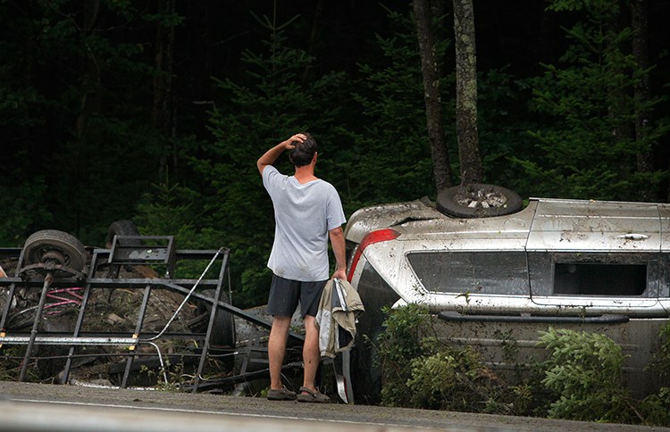 A man surveys the damage to a vehicle that crashed on Interstate 295 at mile 25 northbound in Freeport on Friday.