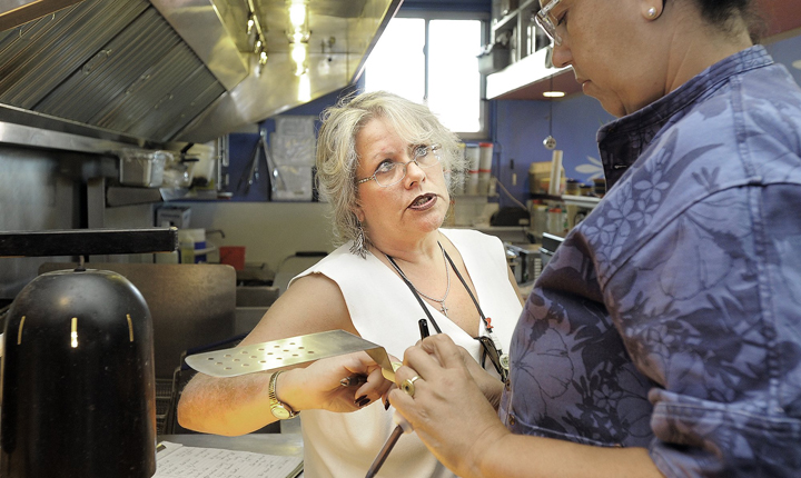 Portland health inspector Michele Sturgeon goes through the kitchen at El Rayo Taqueria on Monday, September 24, 2012 with executive chef Cheryl Lewis.