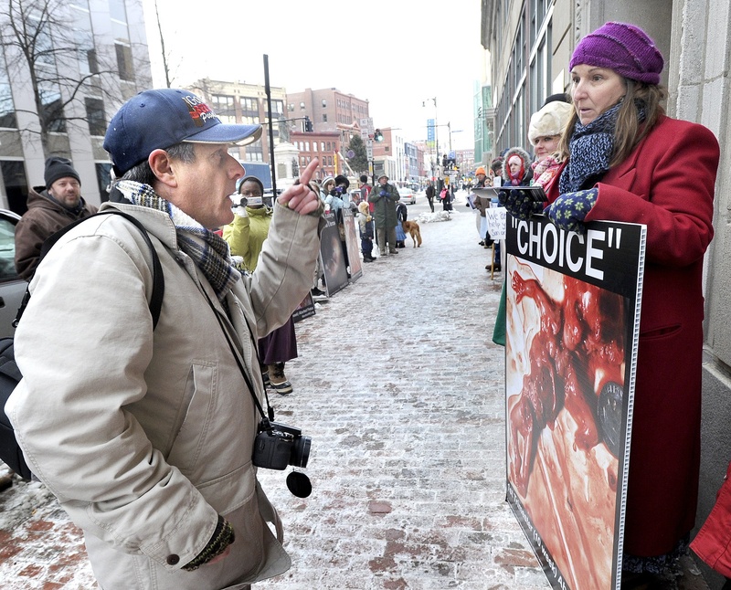 Pro-choice and anti-abortion protesters exchange words in front of the Planned Parenthood clinic at 443 Congress St. in Portland in January. City councilors decided Tuesday, Sept. 10, 2013 to schedule a hearing on a proposal to shield women from protesters who gather outside the Planned Parenthood offices downtown.