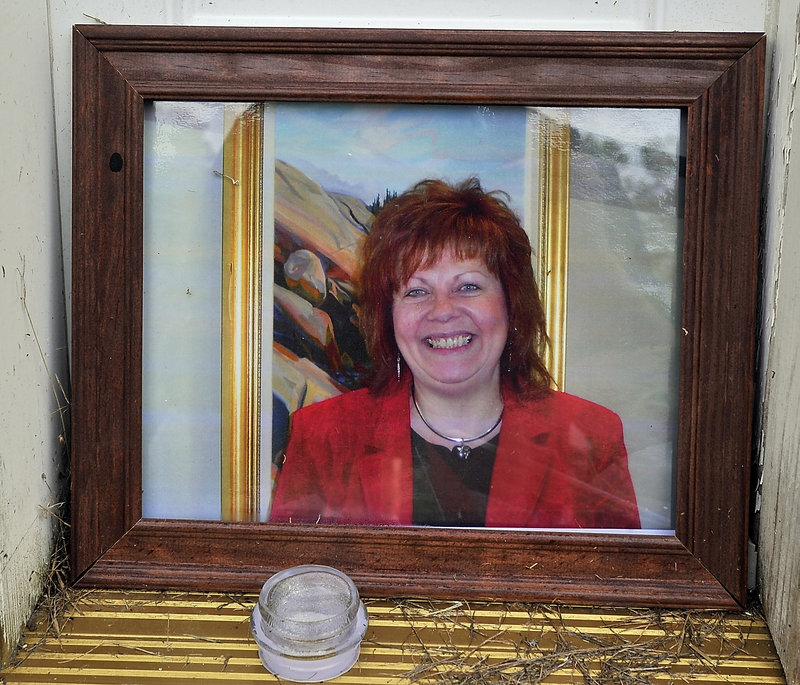 This portrait of Lynn Arsenault, 55, was among the items in a memorial laid at her doorstep Tuesday, Sept. 3, 2013. Police have charged Todd Gilday, 44, with her murder. Arsenault's son Mathew Day was also shot and injured in the incident at the Waldo Avenue house that Arsenault owned.