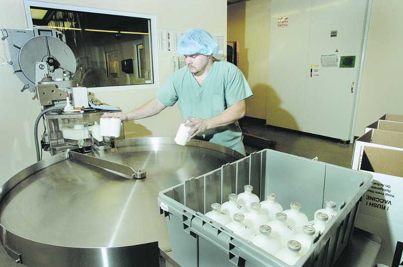 Brett Gray, of Waterville, packages up bottles of vaccine for shipment while working at Maine Biological Laboratories in Winslow Oct. 12, 2004.