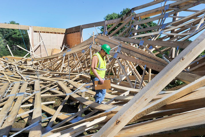 Windham code enforcement inspector Wayne Mathews looks over the damage to the arena on Wednesday.