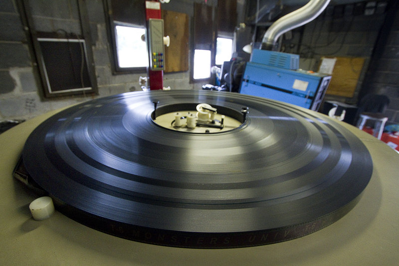 In this July 2013 file photo, a feature film, on 35 mm film, awaits projection in the Saco Drive In's projection room. Starting in 2014 movies will no longer be available on film, and drive-in theaters will have to convert to digital projection. The Saco Drive-In has won a new digital projection system Wednesday, Sept. 11, 2013 that will allow the 74-year-old theater to continue operating.