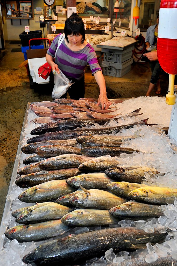 Bie Wu of Portland studies her options at the market.