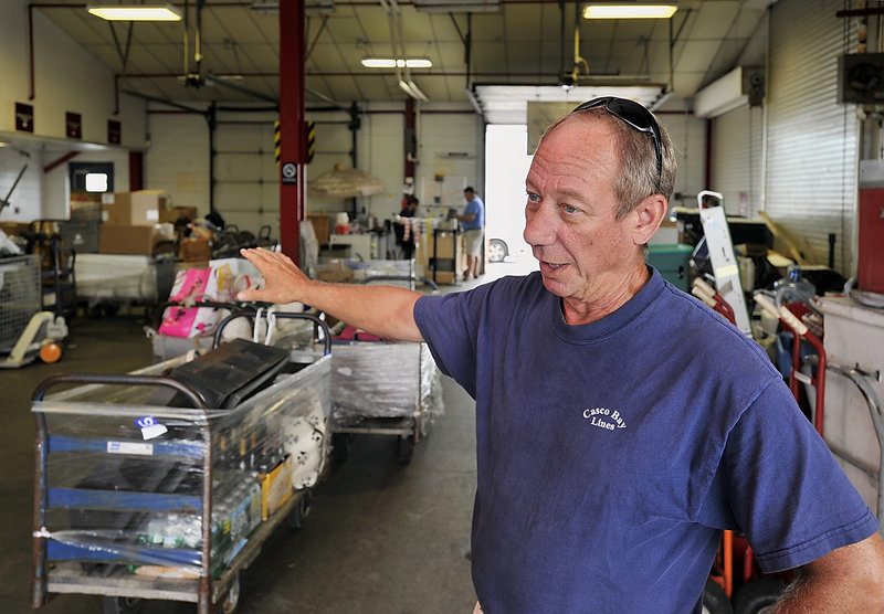 Larry Legere, who has served for 40 years as operations agent for Casco Bay Lines, points to the terminal’s cargo area as he talks about planned improvements.