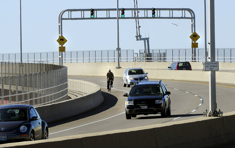 Joe Lawlor makes the final turn on his bicycle commute across the Casco Bay Bridge. He overcame his “dread” of cycling there.