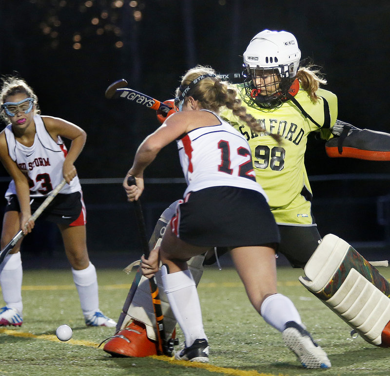 Sanford keeper Teaghan McCormack can’t keep Maddy Dobecki, left, from tapping home a second-half goal during Monday’s game in Scarborough.