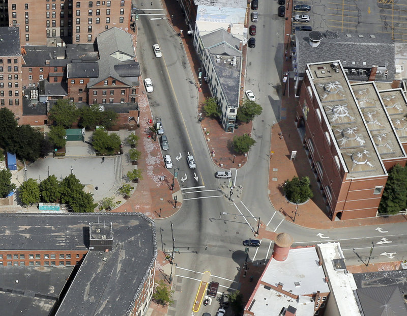 Portland’s City Council voted Monday to sell part of Congress Square Plaza, left, as well as consider a redesign of the intersection of Congress and High streets.