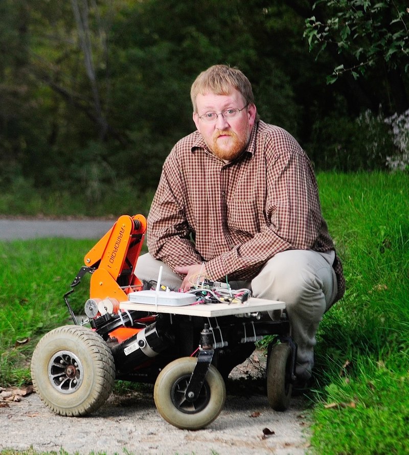 Paul Fowler, a maker from Gardiner, shows his robot that is controlled by his cellphone. He is preparing to attach a robotic arm to the robot.