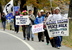 David Leaming/Morning Sentinel Marchers who oppose the use of drone technology, led by Jason Rawn, make their way through Skowhegan along Route 2 on Sunday. Organizer Bruce Gagnon of Veterans for Peace holds his sign at center.