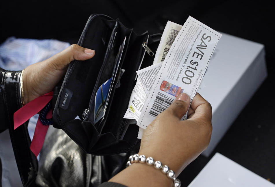 Felicia Evans Long, a program analyst at the National Institutes of Health who is currently furloughed due to the government shutdown, puts coupons in her wallet while running errands. The government shutdown has affected a widespread and diverse work force, sending home thousands of workers throughout Maine and elsewhere, and forcing others to work without knowing when, or if, they will get paid.