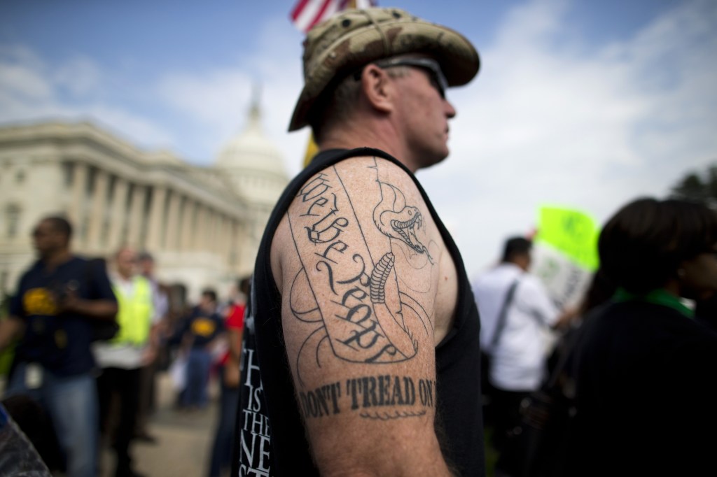 Tea party supporter Greg Cummings of Cincinnati, Ohio, watches a rally with the Democratic Progressive Caucus and furloughed federal employees against House Republicans on Capitol Hill in Washington on Friday. Cummings attended the rally to blame Senate Democrats for the government shutdown.