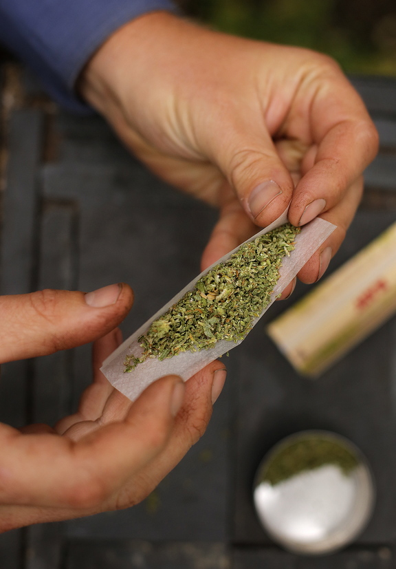 A smoker rolls a marijuana cigarette in Portland. Youth advocates worry about the impact of a campaign supporting legalization of the drug.