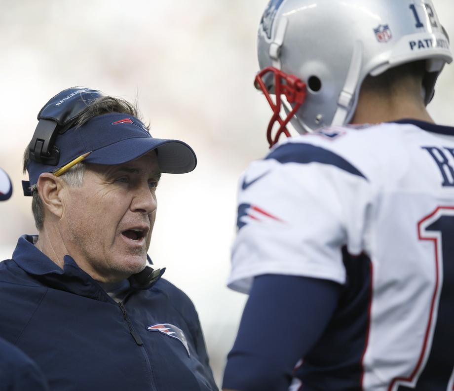Patriots Coach Bill Belichick talks to quarterback Tom Brady during a 30-27 overtime loss to the New York Jets at East Rutherford, N.J. on Sunday. Brady had a sub-par performance, finishing 22 of 46 for 228 yards.