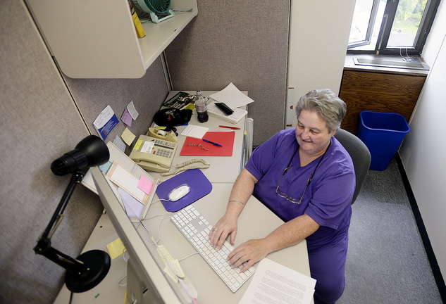 Lucie Tardif, 57, a student at the University of Southern Maine, works in the Office of Public Affairs at USM in Portland on Friday.