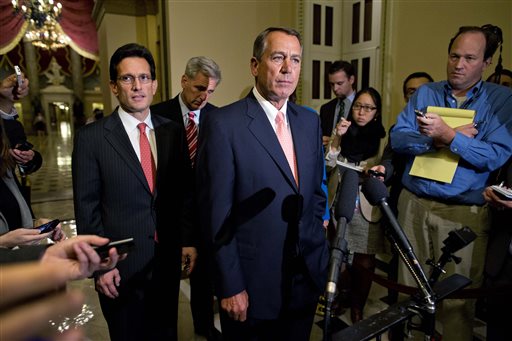 House Majority Leader Rep. Eric Cantor, R-Va., left, and House Majority Whip Rep. Kevin McCarthy, R-Calif., rear center, look on as Speaker of the House Rep. John Boehner, R-Ohio, pauses during a news conference on Capitol Hill on Tuesday in Washington. Congress was unable to reach a midnight deadline to keep the government funded, triggering the first government shutdown in more than 17 years.