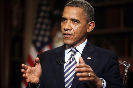 In this photo taken Friday, Oct. 4, 2013, President Barack Obama defends the shaky rollout of his health care law. He said frustrated Americans "definitely shouldn't give up" on the problem-plagued program.