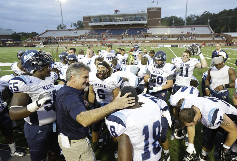 Maine Coach Jack Cosgrove gathers with his team earlier this season.