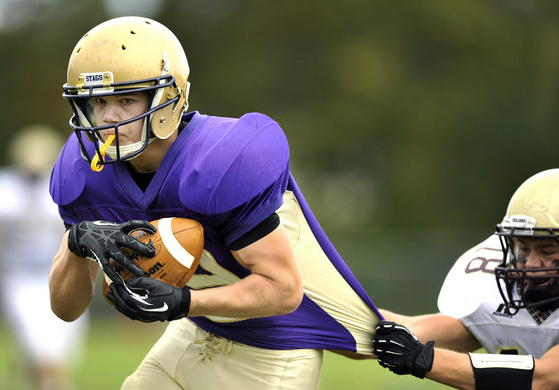 Liam LaFountain of Cheverus breaks away from Cody Lynn of Thornton Academy and scores a first-half touchdown Saturday during Cheverus' 56-7 victory. The Stags, who have won 40 of their last 41 games, are 6-0 this season.