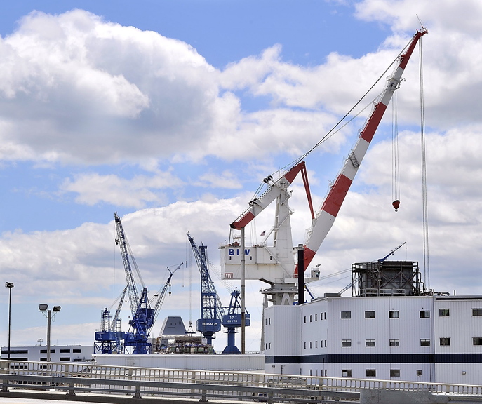 Gordon Chibroski/Staff Photographer In this June 2013 file photo, cranes at Bath Iron Works fill the sky across the highway in Bath, Maine.